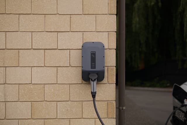 a wall mounted black EV charger 