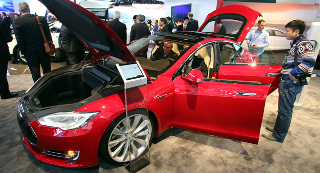 Red Tesla Model with all its doors opened