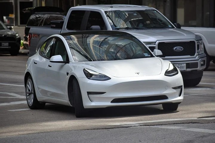 a white Tesla on the road