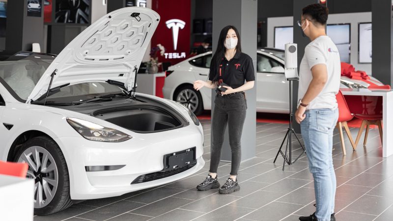 a white tesla in a workshop