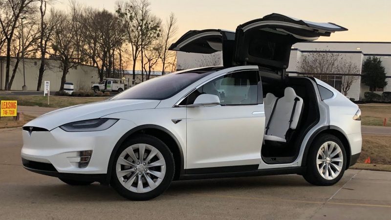 White Tesla Model X with doors open